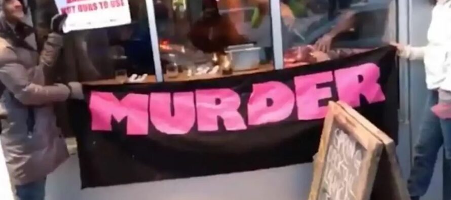 A Hunter Breaks Down Deer Leg in Front of Vegan Protesters